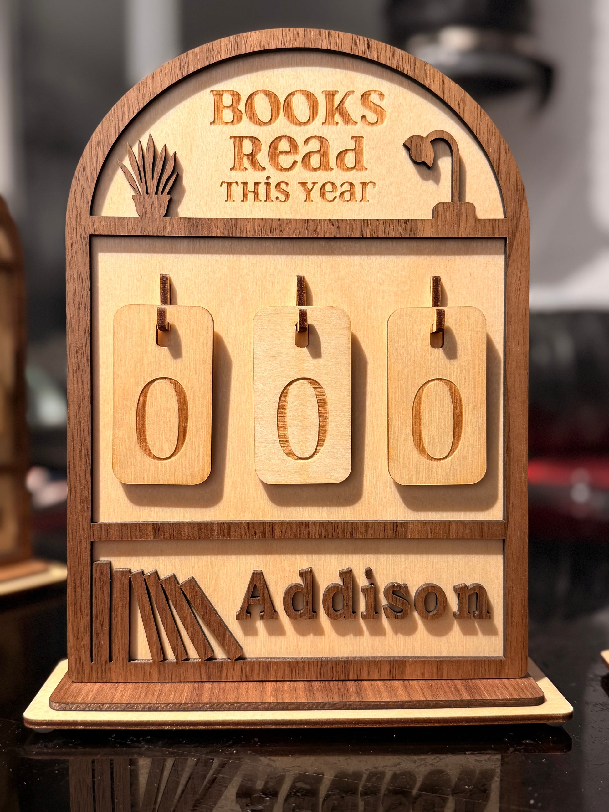Wooden plaque with 'Books Read This Year' display for Addison